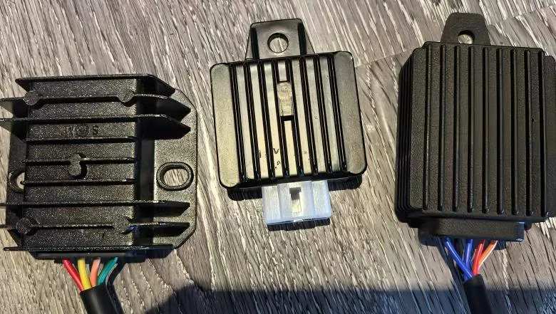 A close-up of TR10W GPS trackers, showcasing their camouflaged design that mimics the appearance of motorcycle rectifiers. TR10W Great Will
